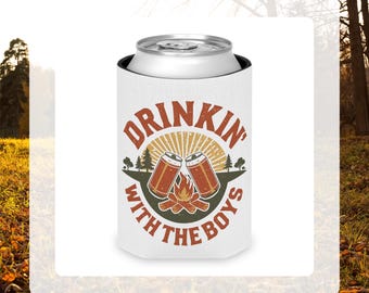 May include: White can cooler with the text "DRINKIN' WITH THE BOYS" in a circular design. The design includes two beer cans, a campfire, and trees. The cooler is designed to keep beverages cold.
