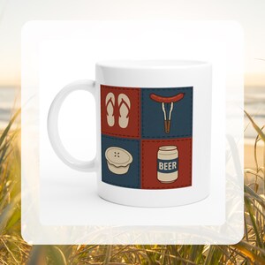 May include: White ceramic mug with a design of four squares. The squares show flip-flops, a sausage with tongs, a pie, and a beer can with the word "BEER". The mug has a curved handle.