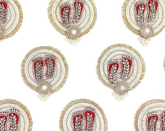 May include: Ornate, circular decorative pieces featuring a red foot design with silver embellishments. Each piece is surrounded by white beads and a gold-colored trim. A pearl-like bead is at the bottom center of each piece.