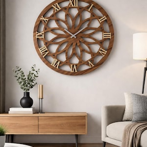 Könnte beinhalten: Eine große, runde Wanduhr mit einem dunkelbraunen Holzrahmen und einem komplexen, durchbrochenen geometrischen Muster. Das Zifferblatt zeigt goldfarbene römische Ziffern und zwei dünne, silberfarbene Zeiger in der Mitte.