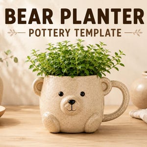 May include: A beige speckled ceramic bear-shaped planter with a handle, featuring a small bear face with black eyes and a nose. The text BEAR PLANTER POTTERY TEMPLATE is displayed above the planter, which contains a small green leafy plant.