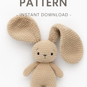 May include: A light brown crocheted bunny toy with long, floppy ears and a round head. The bunny has small black eyes and a stitched nose and mouth. The image includes the text "CROCHET PATTERN - INSTANT DOWNLOAD -" in a dark grey font.