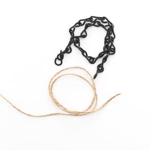 May include: A black metal chain with a hook and a length of natural twine.