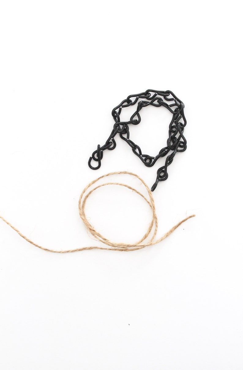 May include: A black metal chain with a hook and a length of natural twine.