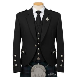 May include: A black formal jacket, waistcoat, and tie set on a mannequin. The jacket has silver buttons and shoulder detailing. A silver thistle brooch is on the lapel. The outfit is completed with a tartan kilt and a silver sporran.