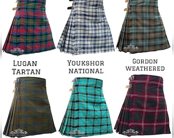 May include: Six pleated kilts with adjustable side straps, labeled as Lugan Tartan, Youkshor National, Gordon Weathered, Kennedy Weathered, Highland Dragon, and Crawford Tartan. The text at the top reads AVAILABLE IN 50+ TARTANS, showcasing various plaid patterns.