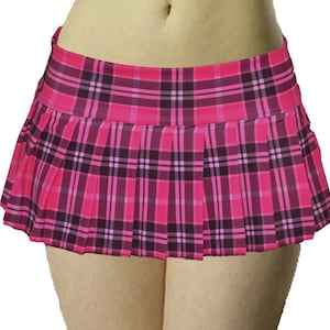 May include: A pink and black plaid pleated mini skirt. The skirt features a wide waistband and a classic plaid pattern in shades of pink and black. The skirt is designed with a pleated style, creating a flared silhouette.