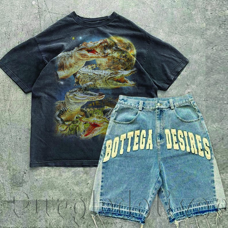 May include: A dark gray t-shirt with a graphic of several alligators and a pair of light blue denim shorts. The shorts have the words "BOTTEGA DESIRES" in white lettering across the back pockets. The shorts have a distressed hem.