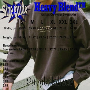May include: A brown unisex crewneck sweatshirt with the text "Heavy Blend" and a size guide. The size guide shows measurements in centimeters for width, length, and sleeve length. The sweatshirt has a relaxed fit.
