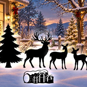 May include: A black metal silhouette set featuring a large pine tree, a stag with antlers, a doe, a fawn, and a log with three wrapped gift boxes. The flat, dark figures are arranged together to create a festive outdoor holiday display.