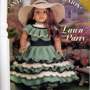 May include: A doll in a green crochet dress with white and black trim, and a wide-brimmed straw hat. The doll is part of the "Antebellum Collection" and is designed by Carol Hegar. The text "Lawn Party" is also visible.