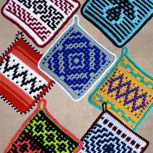 May include: Seven handmade crochet potholders in various colours and geometric patterns. Each square potholder has a loop for hanging. Colours include red, black, white, blue, yellow, and green.