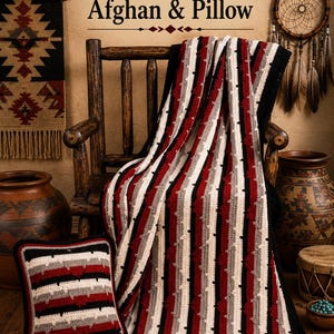 May include: A crochet afghan and matching square pillow featuring a striped pattern in black, white, gray, and deep red. The text Cherokee/Navajo Native American Afghan & Pillow is displayed above the items, which are draped over a wooden chair.