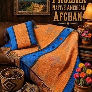 May include: A textured orange and blue woven afghan blanket with fringe edges and a matching square throw pillow. The fabric features a geometric pattern with raised details. The text PHOENIX NATIVE AMERICAN AFGHAN is visible in the upper right.