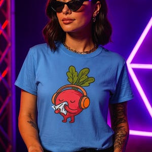 May include: A light blue t-shirt with a cartoon radish design. The radish wears headphones and holds a tissue. The person is wearing sunglasses and a gold necklace. The background has purple neon lights.