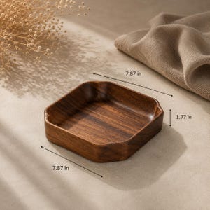 May include: A square dark brown wooden tray with rounded corners and a smooth finish. The tray features dimensions of 7.87 inches in width and length, with a height of 1.77 inches, as indicated by the measurement lines visible in the image.