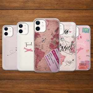 May include: Five clear phone cases with travel-themed designs. One case features a pink world map with a dotted airplane path and a boarding pass. Other cases have a pink airplane, the word "Travel", and travel-related graphics.