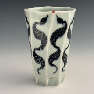 May include: A set of three ceramic nesting bowls in shades of blue, green, and white. The bowls feature a speckled glaze and a simple, modern design. The largest bowl measures approximately 6 inches in diameter.