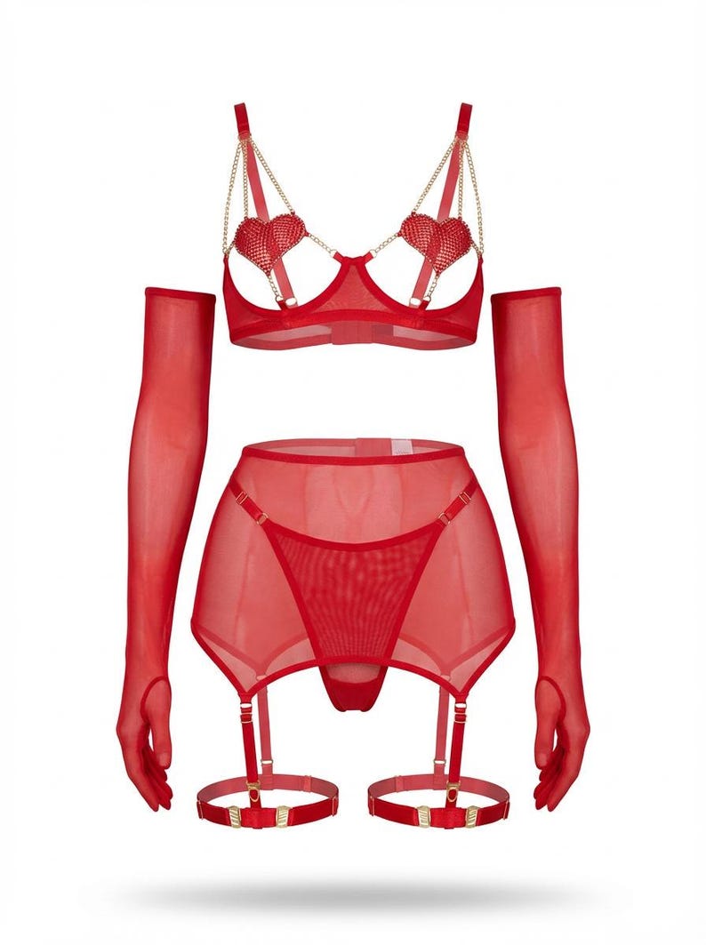 May include: A red lingerie set featuring a bra with heart-shaped accents and gold chain straps, a garter belt, a thong, and sheer gloves. The set is made of a sheer, lightweight material.