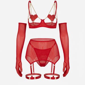 May include: A red lingerie set featuring a bra with heart-shaped embellishments and gold chain straps, a garter belt, a thong, and sheer gloves. The set is made of a sheer, lightweight fabric. The bra has underwire support.