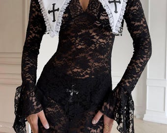 May include: Black lace dress with long sleeves and flared cuffs. The dress features a white collar with black crosses. The collar is trimmed with delicate lace. The dress is a unique and eye-catching garment.