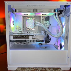 May include: White computer case with internal components, including a graphics card labeled "ASUS GEFORCE RTX." The case features multiple fans with colorful LED lighting. The top of the case is labeled "THERMALRIGHT."