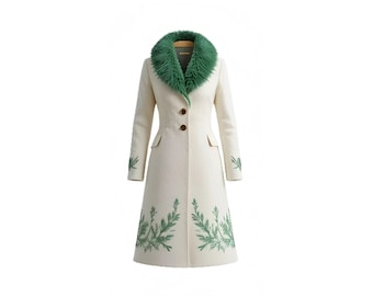 May include: Cream-colored coat with a green faux fur collar and leaf embroidery. The coat features a tailored fit, two brown buttons, and pockets. The sleeves and hemline are adorned with green leaf designs, creating a stylish, elegant look.