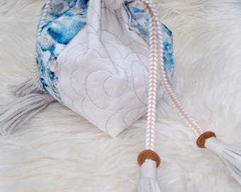 Drawstring bags with embroidery and hand made leather tassels.