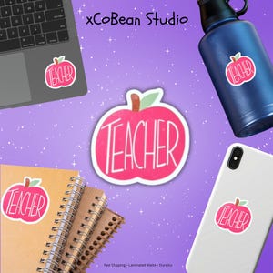 May include: A collection of teacher-themed stickers and accessories. The stickers feature a red apple design with the word "TEACHER" in white. Items include a laptop, water bottle, phone, and notebooks, all with the apple sticker. The background is purple.
