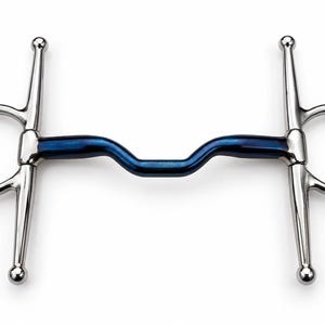 May include: A full cheek horse bit featuring a central blue metal mouthpiece with a curved port design. The bit includes two silver-coloured stainless steel rings on each side with vertical bars ending in small rounded knobs at the top and bottom.