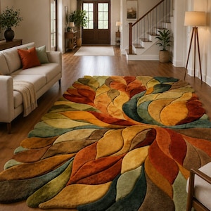 May include: A rectangular area rug featuring a three-dimensional, sculpted leaf pattern in a warm palette of burnt orange, mustard yellow, olive green, and deep brown. The textured surface consists of layered, curved shapes that mimic foliage.