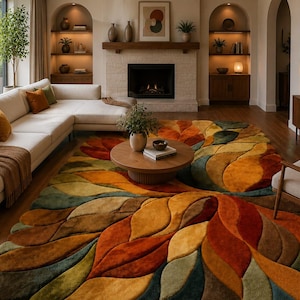 May include: A large area rug featuring a textured, multi-layered leaf pattern in shades of burnt orange, mustard yellow, deep olive green, and teal. The rug has a thick, plush pile with carved edges that define each individual leaf shape.