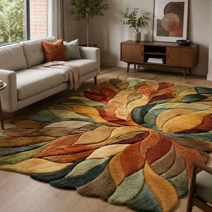 May include: A large rectangular area rug featuring a three-dimensional, sculpted leaf pattern in a palette of burnt orange, mustard yellow, deep forest green, and earthy brown tones, with a thick, plush texture and layered, overlapping organic shapes.