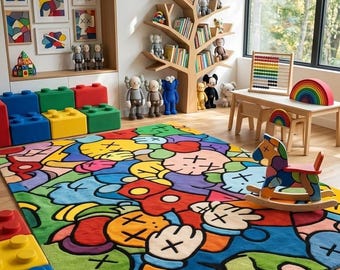 May include: A large rectangular area rug featuring a vibrant, multi-colored graphic pattern with cartoon-style hands, faces with X-shaped eyes, and bold black outlines. The rug displays a mix of red, blue, yellow, green, and orange color blocks.