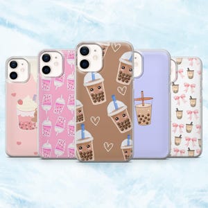 May include: A collection of five phone cases with various designs. The cases feature illustrations of bubble tea, including cups with boba, hearts, and bows. The color palette includes pink, brown, and purple.