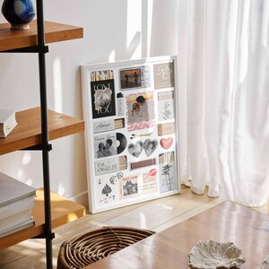 May include: A white framed collage of photos, postcards, and decorative items. The collage includes photos of couples, hearts, and the words "Love You" and "Forever Yours". The collage is displayed near a wooden shelf and a woven basket.