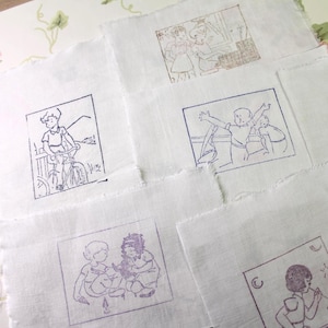 May include: A collection of white fabric squares, each featuring a different vintage illustration in brown and purple ink. The drawings show children at play, including cycling and other activities. The edges of the fabric are raw, giving a handcrafted appearance.