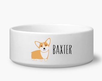 May include: White ceramic dog bowl with a cartoon image of a corgi and the name "Baxter" printed on the front.