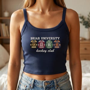 May include: Navy blue ribbed tank top with the text "BRIAR UNIVERSITY hockey club." The top features four hockey jersey designs with player names and numbers: Graham 44, Logan 22, Delaurentis 66, and Tucker 46.