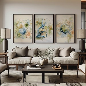 May include: Three framed watercolour art prints. The prints feature images of viruses and a microscope. The colour palette includes blue, green, orange, and beige. The art is displayed above a cream-coloured sofa with brown cushions.