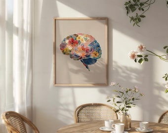 May include: A rectangular framed wall art print featuring a human brain illustration filled with a vibrant watercolour floral pattern in shades of red, blue, yellow, and pink, set against a solid light beige background within a wooden frame.