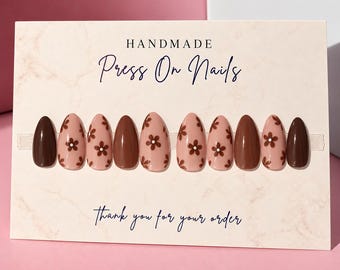 May include: A set of almond-shaped press-on nails displayed on a card labeled HANDMADE Press On Nails and Thank you for your order. The nails feature a mix of solid dark brown and light pink with dark brown flower patterns.