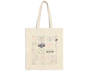 May include: A cream-coloured tote bag featuring a collage of travel stamps in various colours. The stamps display city names such as Tokyo, Dublin, and Sydney, alongside dates and airplane symbols. The bag has long handles and a straightforward design.