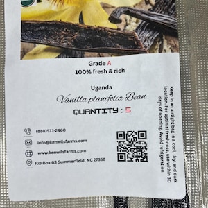 May include: A packet of Kenwils Farms organic vanilla beans. The label states "Grade A, 100% fresh & rich" and "Vanilla planifolia Bean" from Uganda. The quantity is 5. The package also includes contact information and a QR code.