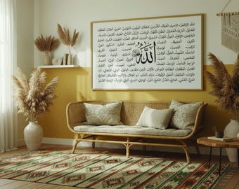 May include: A living room scene featuring a woven rattan sofa with beige cushions, a patterned rug, and a large framed artwork with Arabic script. Dried pampas grass in vases and a small wooden side table complete the decor.