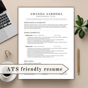 May include: A professional resume template with the name "Amanda Aardsma" at the top. The resume includes sections for professional overview, work experience, and education. A laptop, pen, and coffee cup are in the background.