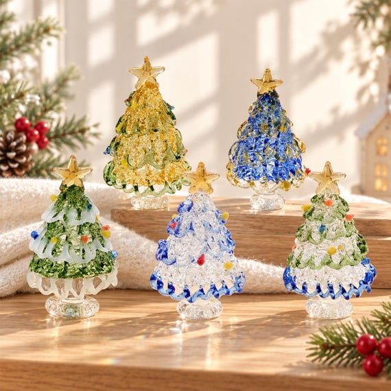 A tiny hand-crafted glass Christmas tree that actually rotates — mesmerizing kinetic desk decor that looks like it belongs in a high-end boutique, not a dollar store.