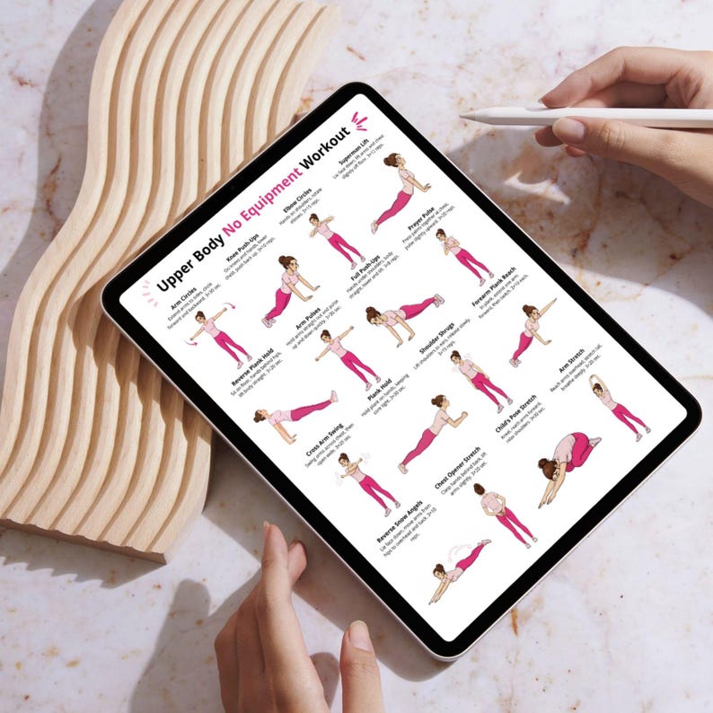 May include: A digital tablet shows an "Upper Body No Equipment Workout" guide. The guide features illustrated exercises in pink and white, including arm circles, push-ups, and stretches. A hand holds a stylus near the screen.
