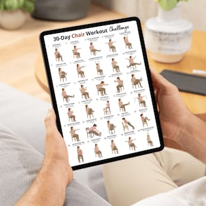 May include: A black tablet showing a 30-Day Chair Workout Challenge. The chart features illustrations of various exercises performed while seated. The tablet is held by a person, with a couch and table in the background.