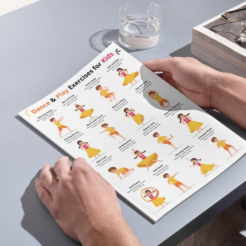 May include: A printed sheet titled "Dance & Play Exercises for Kids" featuring colorful illustrations of children performing various dance moves. The sheet is held by a person, with a glass of water and a stack of books in the background.